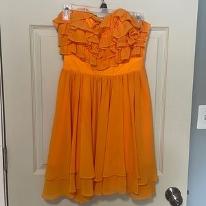 Sweetheart neckline ruffled top,  flowy oranges dress. Falls about mid thigh